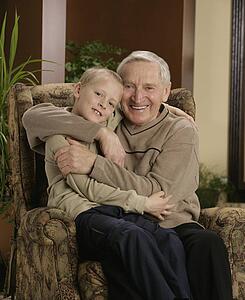 Grandfather hugging grandson
