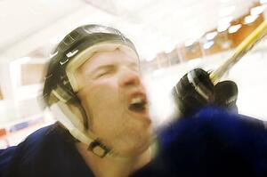 Hockey player getting checked from behind