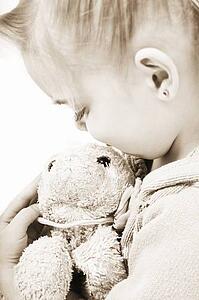 Child holding soft toy
