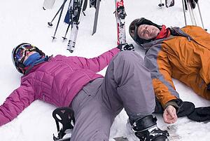 Two skiers resting in the snow, Whistler, BC, Canada