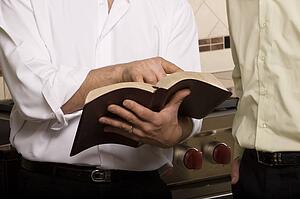 Man showing something in a book