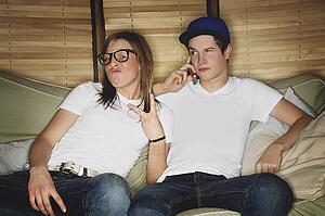 Two people sitting on a couch
