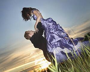 A man lifting his prom date