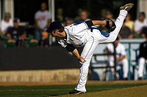 A baseball playing throwing the ball