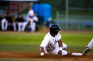 Baseball player sliding onto a base