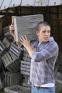Man moving wooden crate