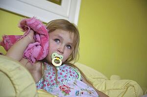 Girl with soother and blanket