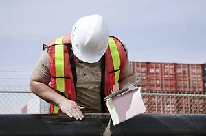 Man inspecting pipe