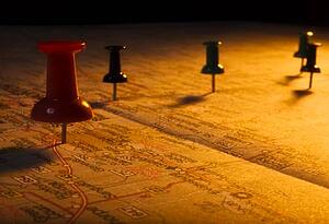 Thumb tacks on a map