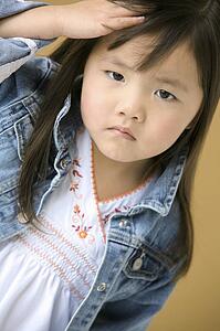 Young girl frowning