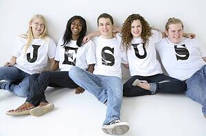 Five teenagers with t-shirts spelling Jesus
