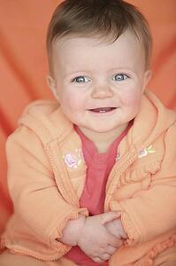 Baby girl in orange jacket