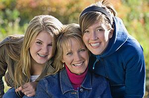 Portrait of mother with two teenage daughters