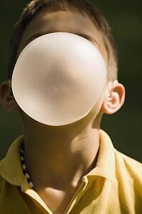 Boy blowing bubble with bubblegum