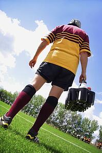Rugby player on the sideline with refreshments