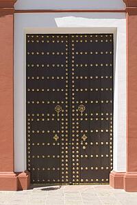 Wooden church doors with brass