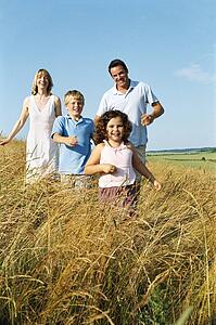 Family running outdoors smiling