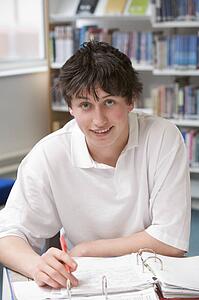 Student writing and studying