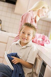 Mother And Son Cleaning Dishes