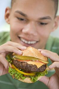 Teenage Boy Eating Burger