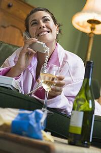 Young woman at home talking on telephone