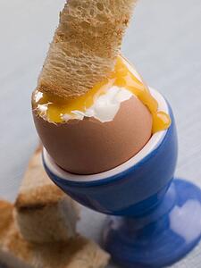 Toasted Soldier being Dipped into a Runny Yolk