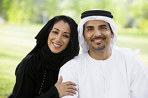 Couple outdoors in park smiling (selective focus)