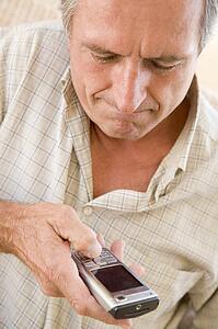 Man using cellular phone indoors