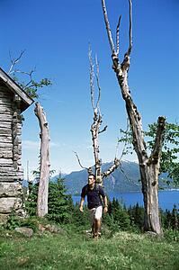 Man outdoors by cabin hiking