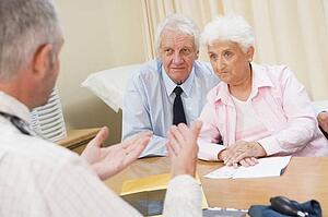 Couple in doctor's office frowning