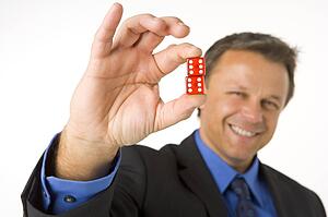 Businessman Holding Two Red Dice 