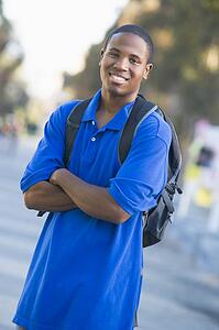 Man standing outdoors smiling (selective focus)