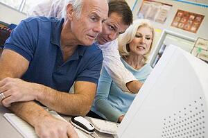 Three people at computer terminal