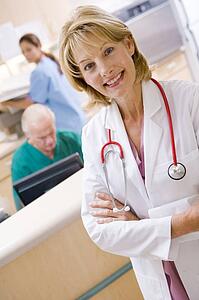 A Doctor And Nurses In The Reception Area Of A Hospital