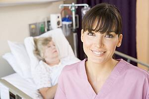 Nurse Standing In Hospital Room, Smiling