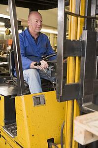 Warehouse worker in forklift