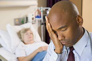 Doctor Looking Tired And Frustrated In Hospital Room