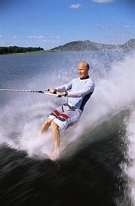 Man bare foot waterskiing