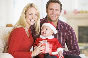 Couple With Baby In Santa Outfit