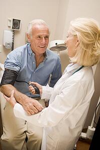 Doctor Checking Blood Pressure Of Man