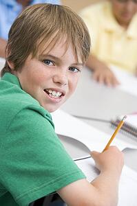 Student in class writing (selective focus)