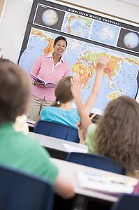 Students in geography class volunteering for teacher (selective focus)