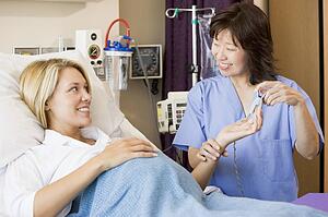 Doctor Taking Pregnant Woman’s Pulse