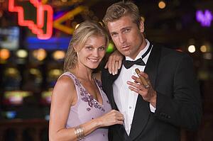 Couple in casino with cigar smiling (selective focus)