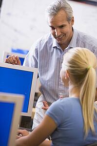 Teacher with female student in computer class
