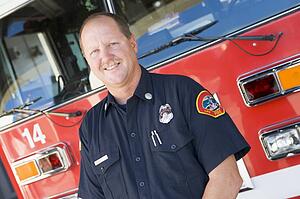 Fireman standing in front of fire engine