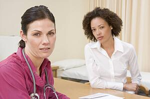 Woman in doctor's office frowning