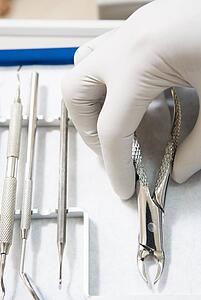 Dental tools with a gloved hand
