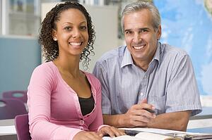 Teacher giving personal instruction to female student