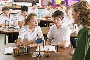 Students performing science experiments in classroom